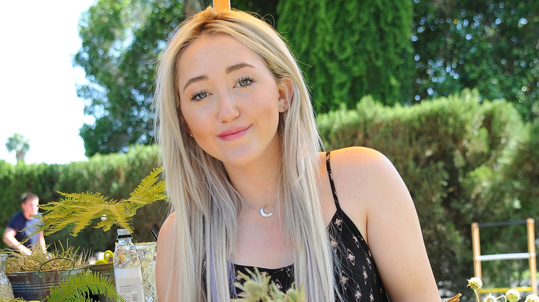 Noah Cyrus posing outdoors