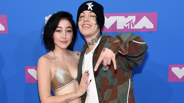 Noah Cyrus with hand on Lil Xan's chest