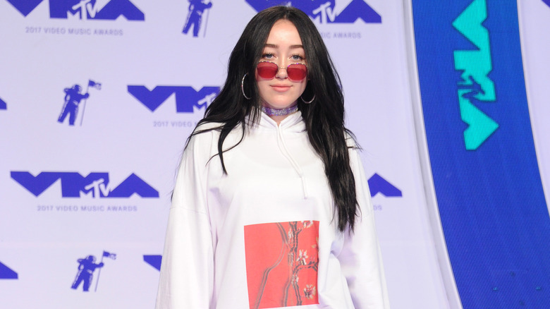 Noah Cyrus wearing pink sunglasses