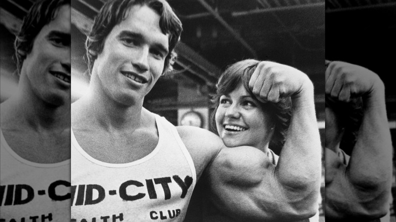 Arnold Schwarzenegger and Sally Field smiling in "Stay Hungry"