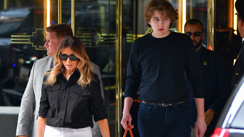 Barron Trump standing next to Melania Trump