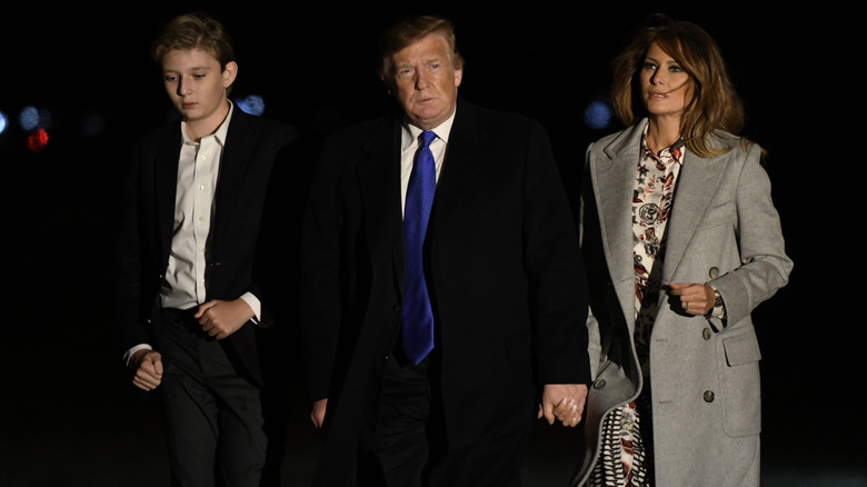 Barron Trump walking with his parents