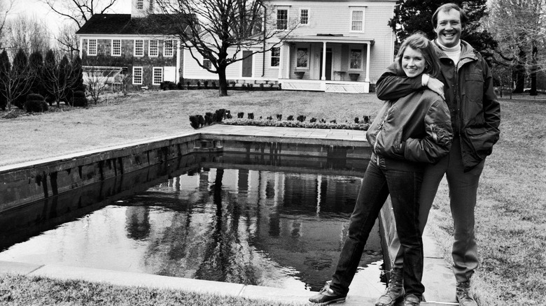 Young Martha and Andy Stewart posing in front of their home