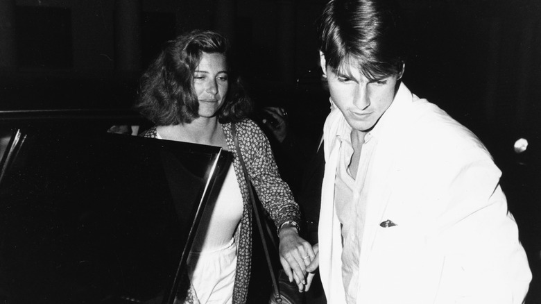 Mimi Rogers and Tom Cruise exit a car in 1987