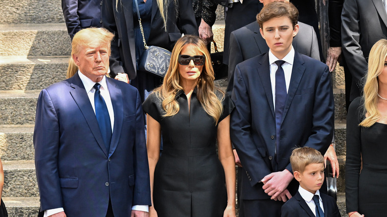 Barron Trump posing with his parents