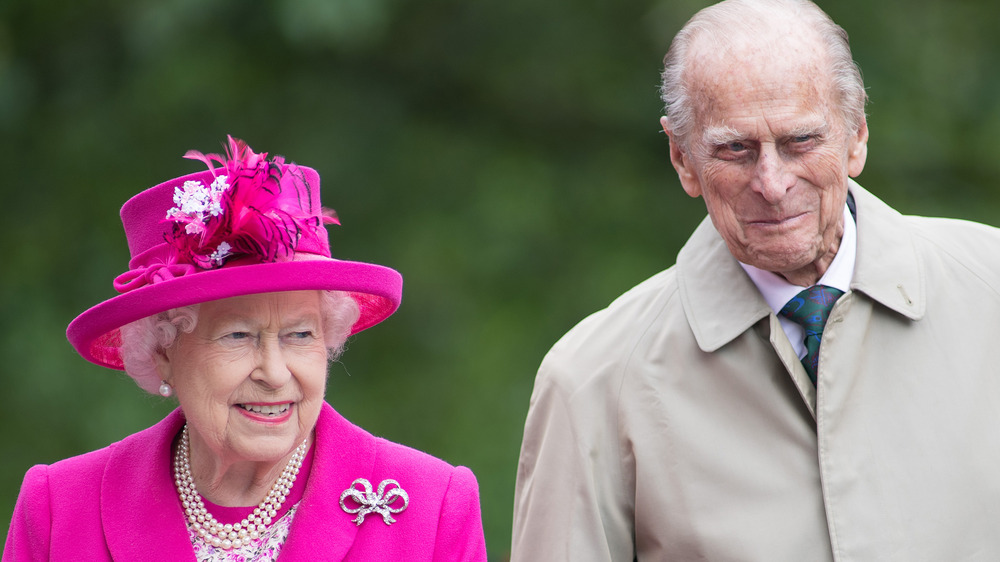 Queen Elizabeth smiles alongside Prince Philip at a royal engagement