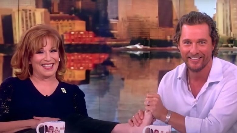 Matthew McConaughey rubbing Joy Behar's foot