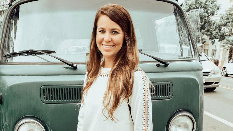 Jana Duggar smiling in front of van