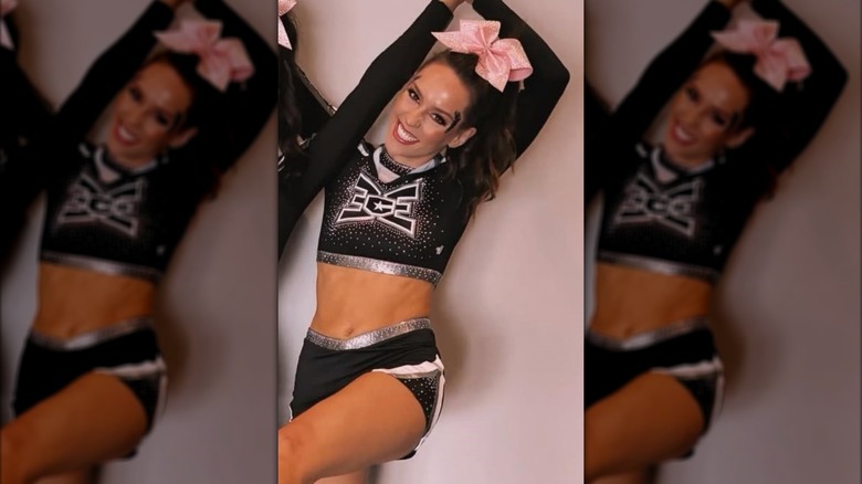 Jordon Hudson wearing black cheerleading uniform and pink hairbow