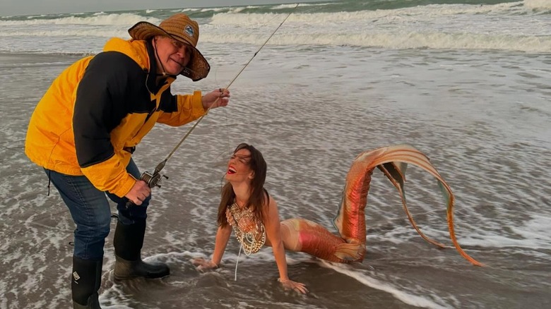 Bill Belicheck dressed as a fisherman and Jordon Hudson as a mermaid