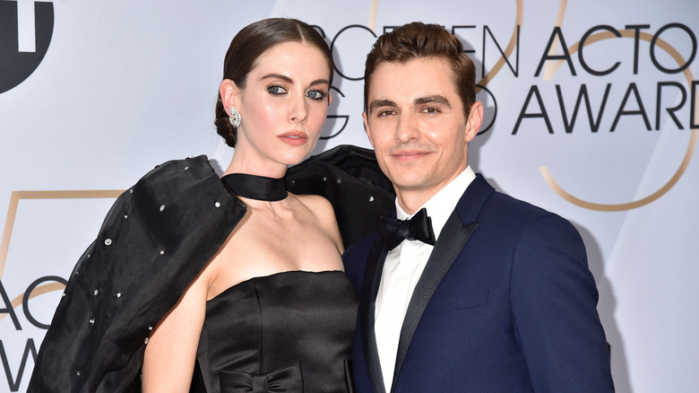 Alison Brie in black gown; Dave Franco in blue suit