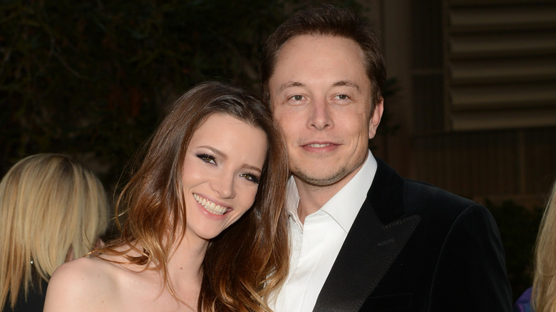 Talulah Riley and Elon Musk pose together on the red carpet.