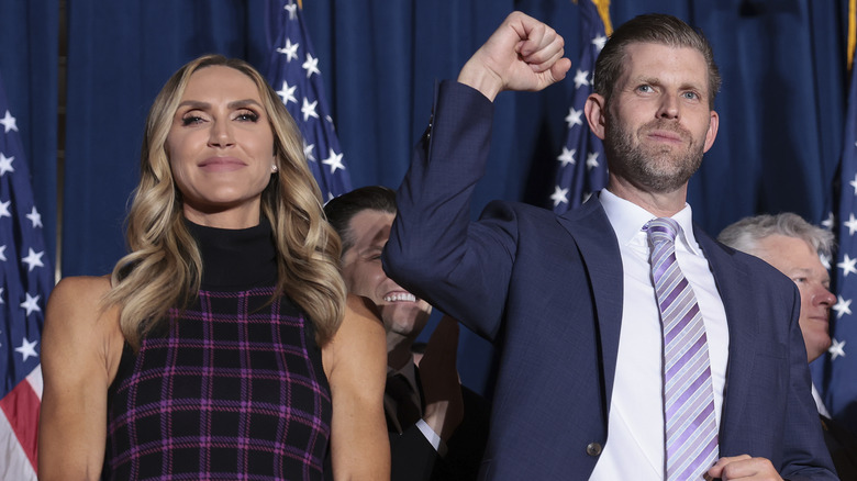 Eric Trump raising fist beside Lara Trump