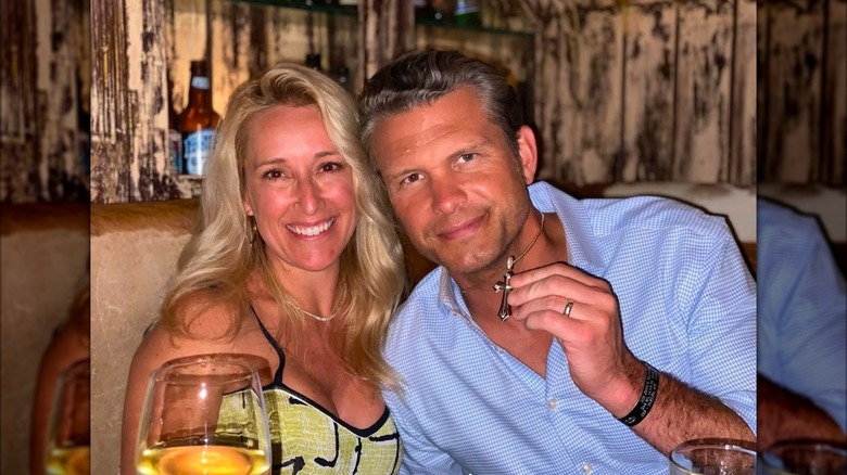 Jennifer Rauchet and Pete Hegseth posing while seated