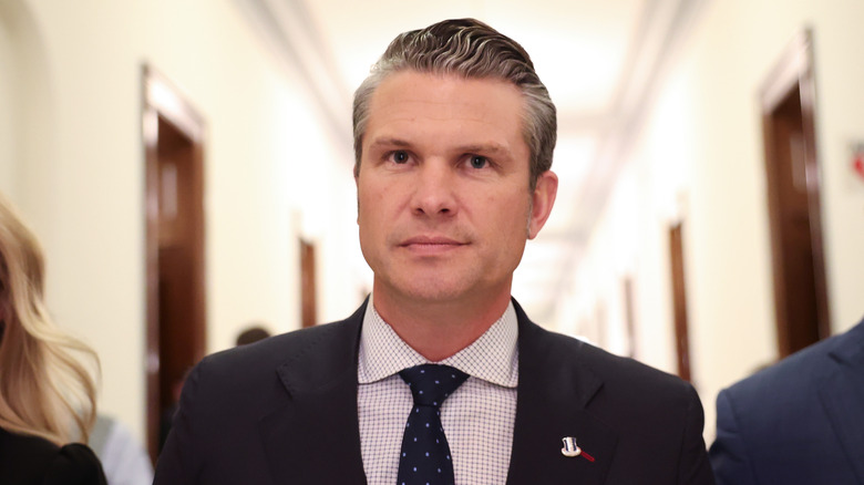 Pete Hegseth arriving for a meeting with U.S. Sen. Joni Ernst; wearing a suit