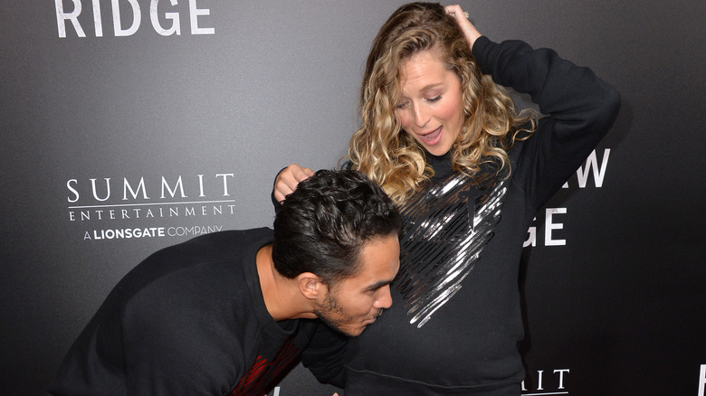 Carlos PenaVega kissing Alexa PenaVega's baby bump