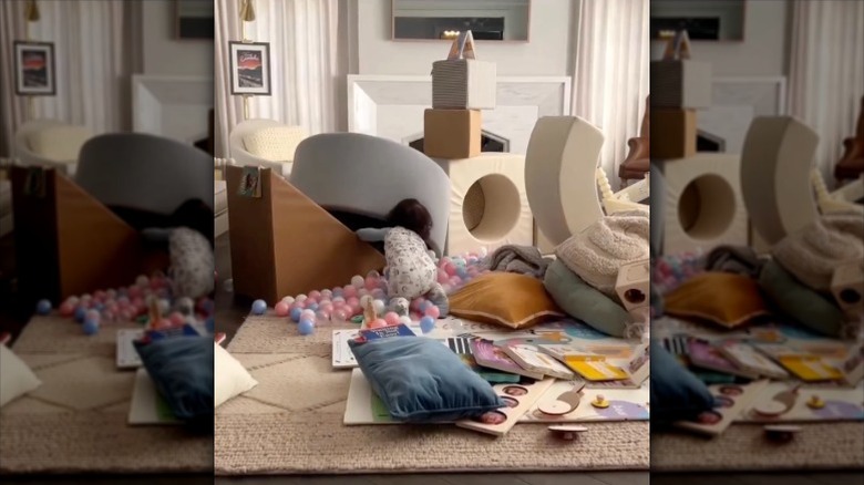 Drew Scott's son playing in a messy living room