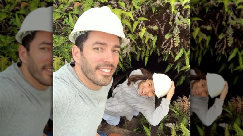 Drew Scott and Linda Phan pose in safety helmets