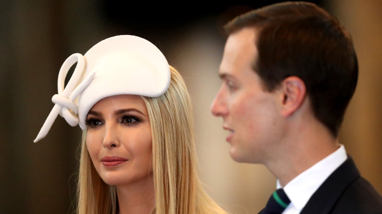 Ivanka Trump wearing a hat next to Jared Kushner