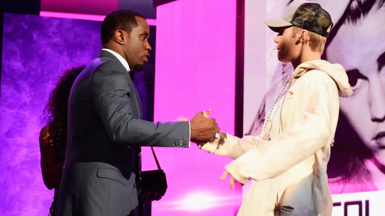 Diddy and Justin Bieber clasping hands