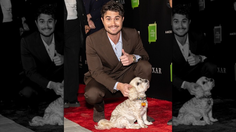 Chase Stokes petting a dog