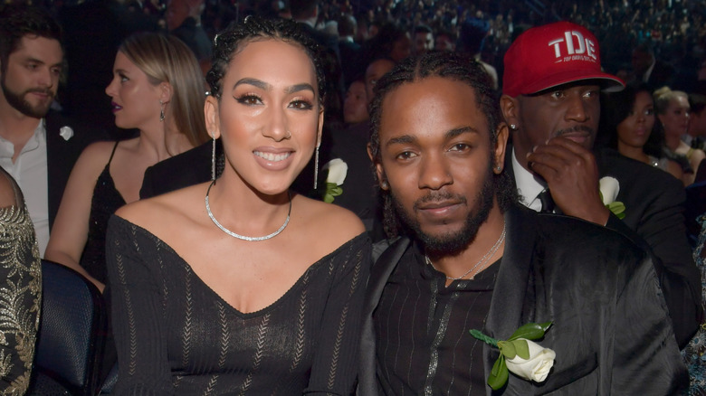 Kendrick Lamar, posing with Whitney Alford at an event