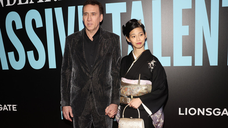 Nicolas Cage and Riko Shibata hold hands