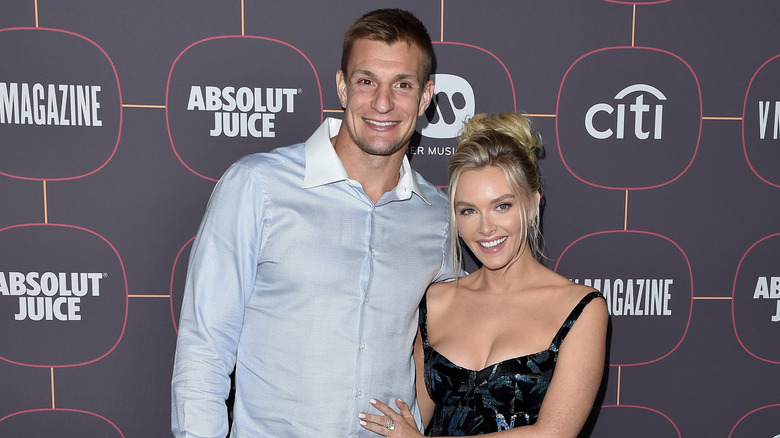 Camille Kostek with hand on Rob Gronkowski's stomach