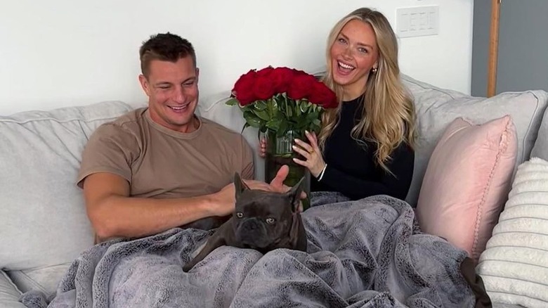 Rob Gronkowski, Camille Kostek on couch with dog