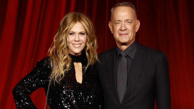 Rita Wilson and Tom Hanks posing in black outfits