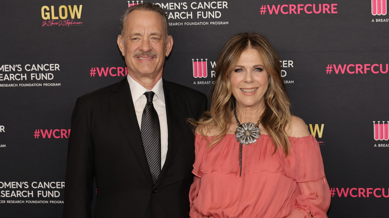 Tom Hanks and Rita Wilson smiling with teeth at "An Unforgettable Evening" Benefiting The Woman's Cancer Research Fund