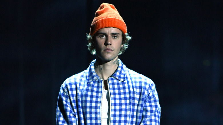 Justin Bieber wearing orange hat