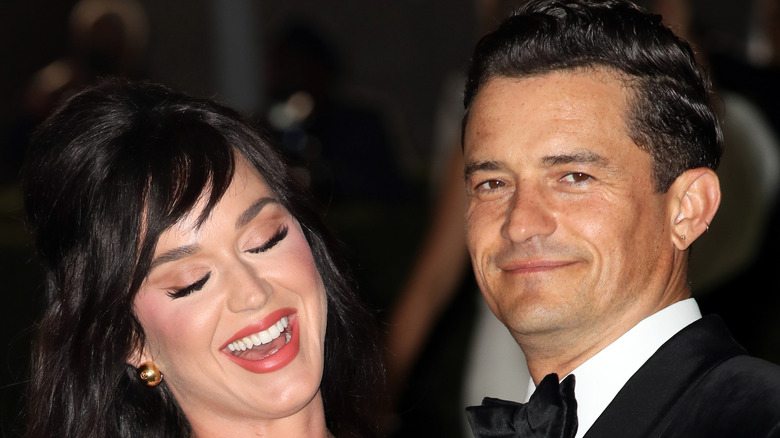 Katy Perry laughing and Orlando Bloom grinning