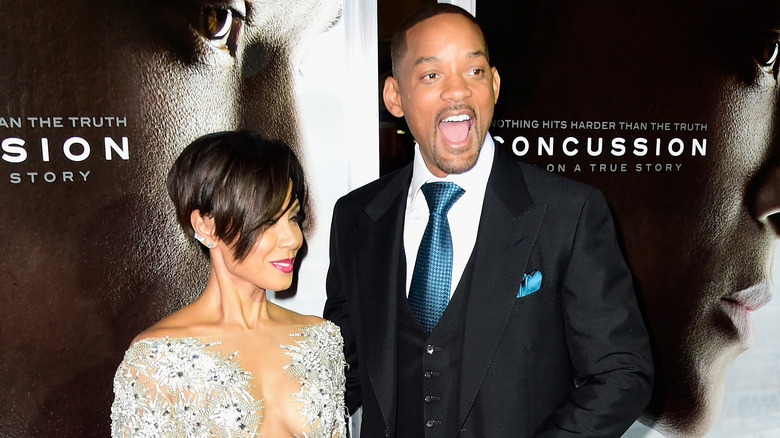 Jada Pinkett Smith with a small smile, Will Smith with a surprised expression at a Concussion screening