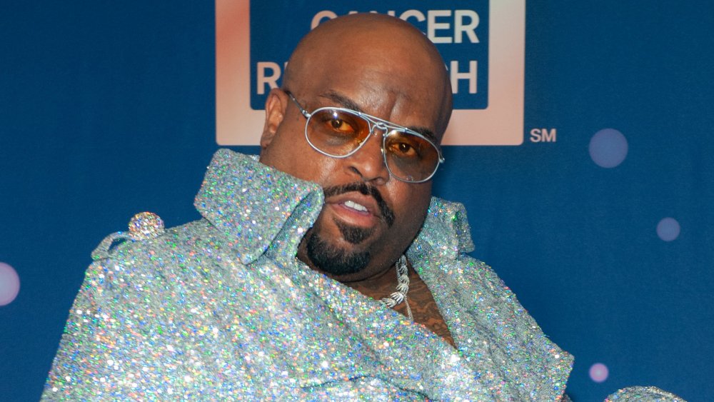 CeeLo Green in a sparkly shirt, posing with a confused expression