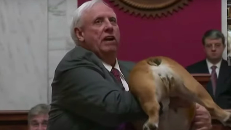 Gov. Jim Justice holding up his dog's butt