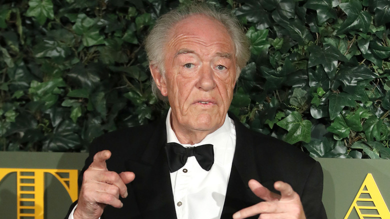 Michael Gambon posing with fingers pointed