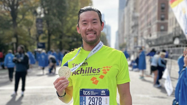 Joe Park holding a medal at the New York City marathon