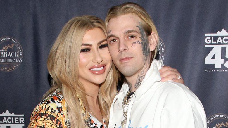 Aaron Carter and Melanie Martin posing on the red carpet