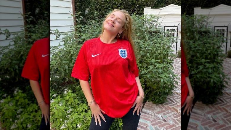 Adele posing in her red England t-shirt