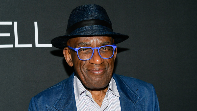 Al Roker smiling wearing hat and blue glasses