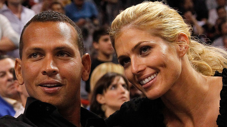 Alex Rodriguez sitting with Torrie Wilson, smiling