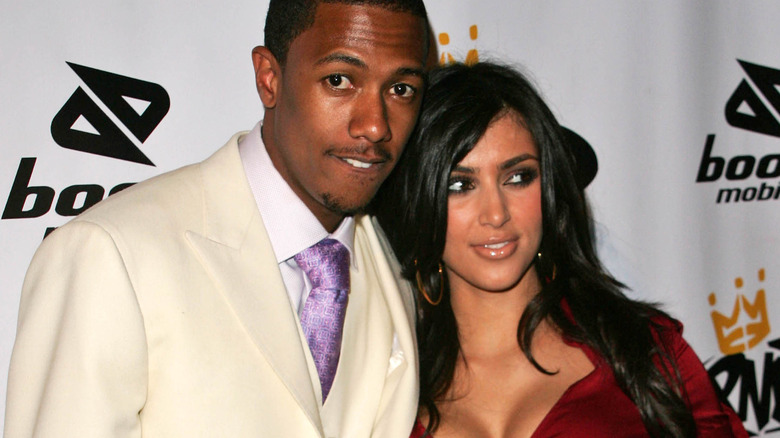 Nick Cannon and Kim Kardashian posing 