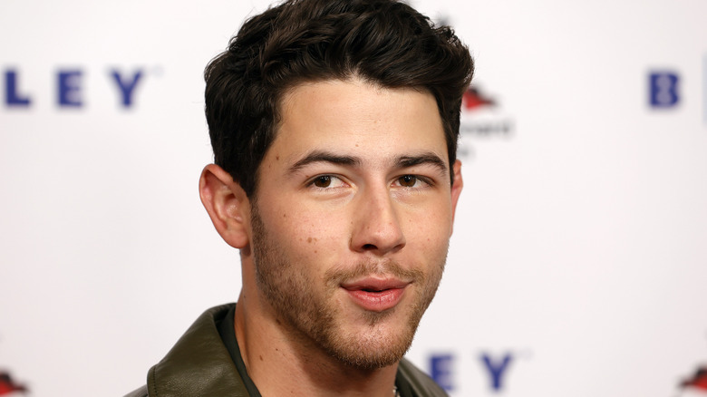 Nick Jonas smirking