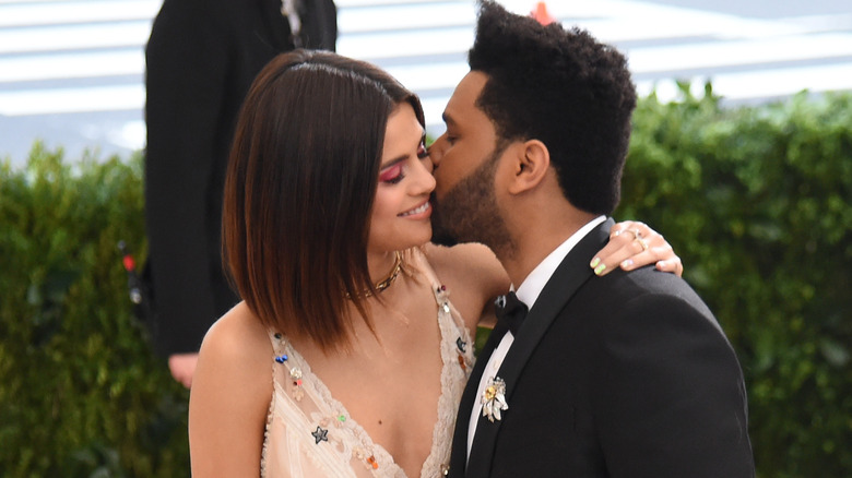 Selena Gomez and The Weeknd kissing