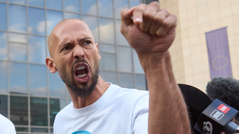 Andrew Tate shouting raised fist