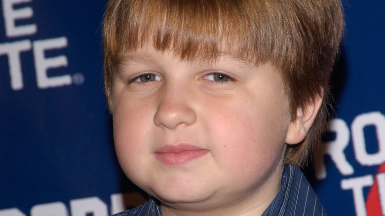 young Angus T Jones with slight smile