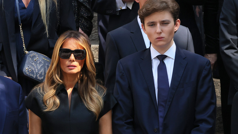 Melania and Barron Trump standing next to each other