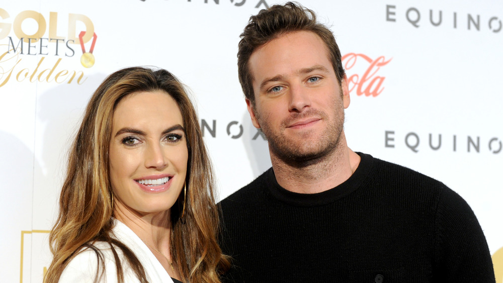 Elizabeth Chambers and Armie Hammer posing at an event