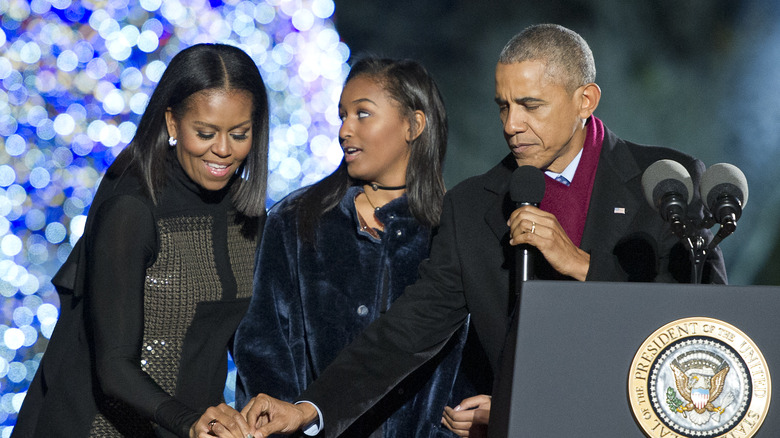 Sasha Obama on stage with Michelle and Barack Obama